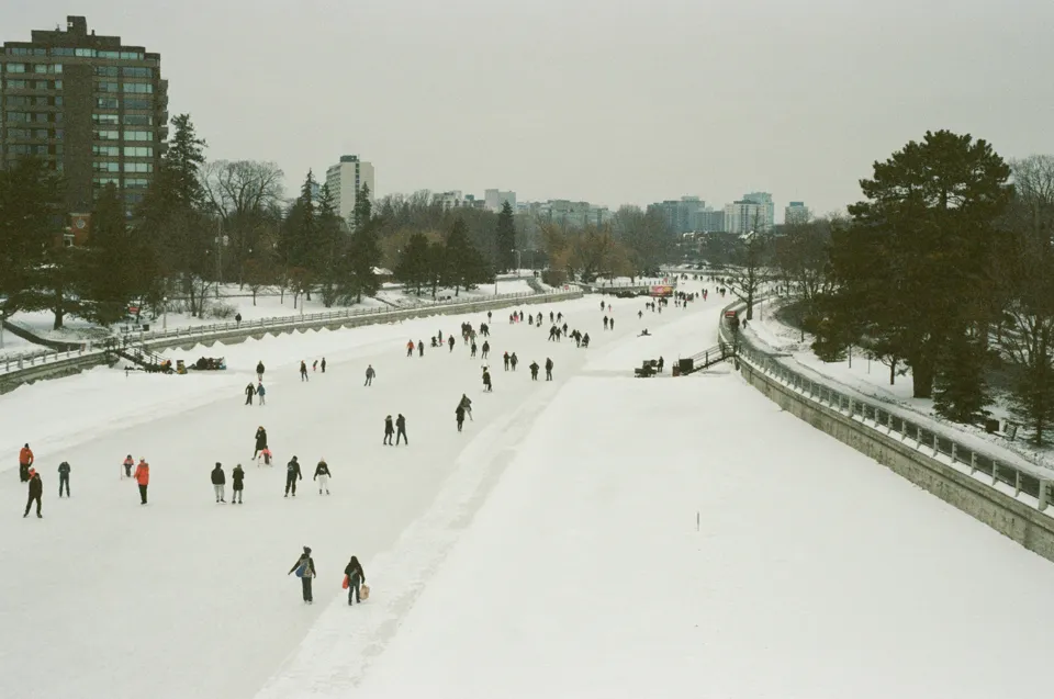 People walking and skating on a frozen canal in Ottawa