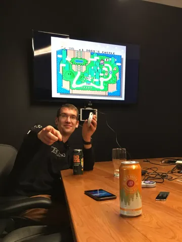 A teammate holding up a retro game