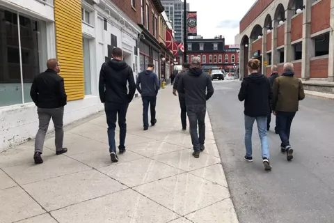 Teammates walking down a downtown street